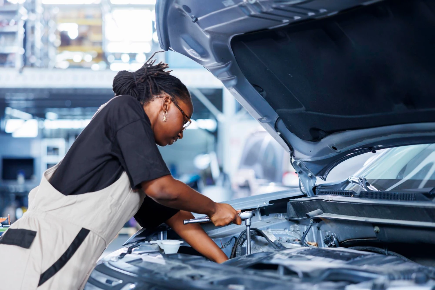 Mobile mechanic working on vehicle